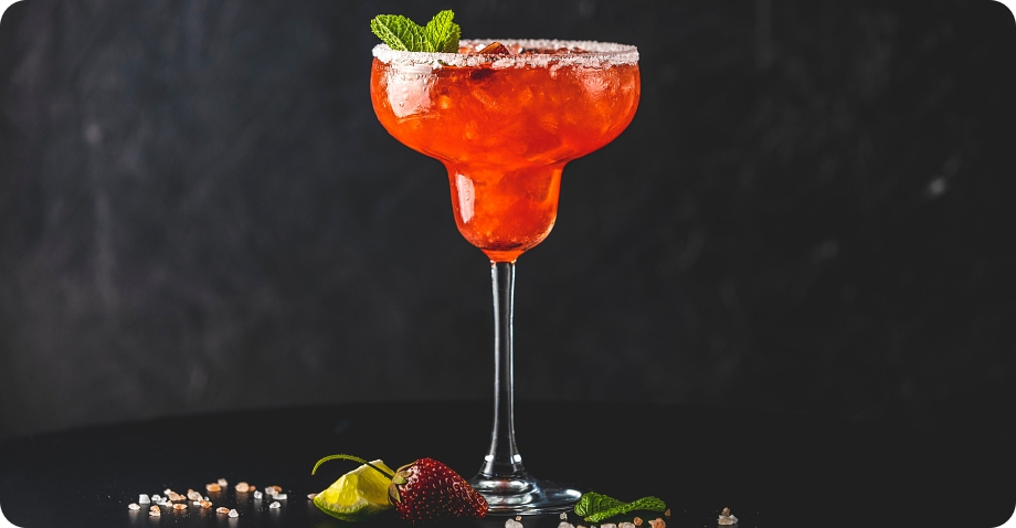 Cocktail in margarita glass with fruit garnish, representing beer, wine, and spirits for liquor license applications.