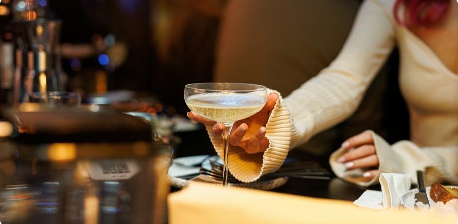 Guest enjoying a champagne cocktail at a bar for Boca Raton liquor license services