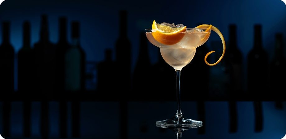 Martini with a citrus twist in a dark bar for a liquor license in West Palm Beach, Florida